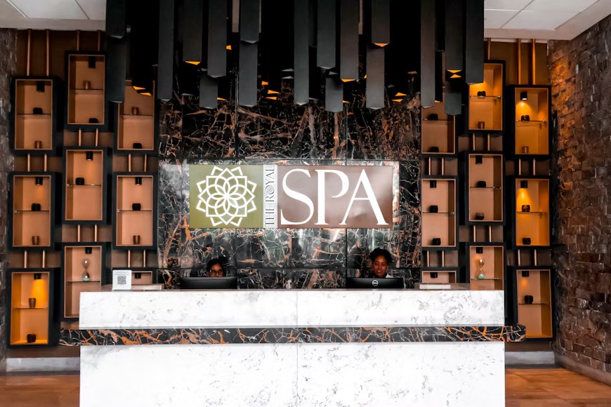 Marble reception desk beneath The Royal Spa sign at Royalton Bavaro